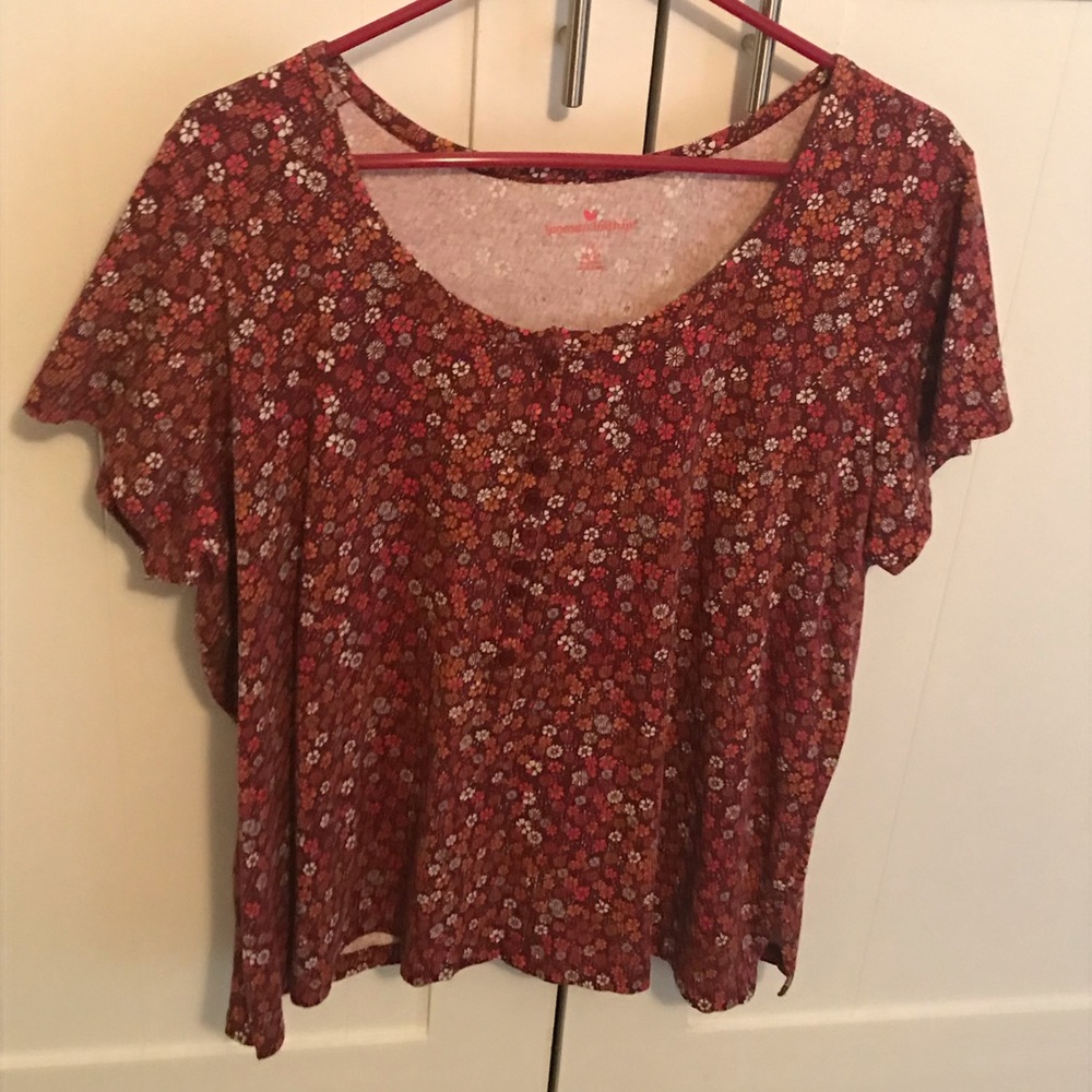T shirt, buttons in front . Short sleeves.